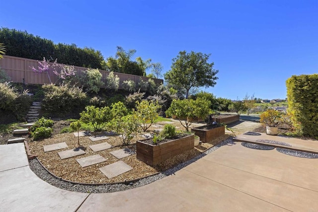 view of patio / terrace with a garden and fence