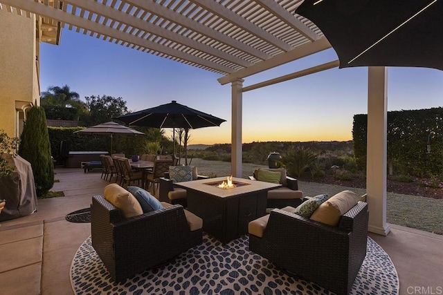 patio terrace at dusk featuring a fire pit, outdoor dining space, and a pergola