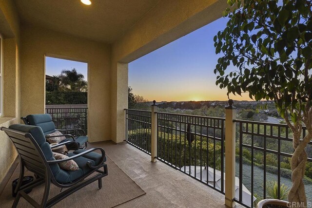 view of balcony at dusk