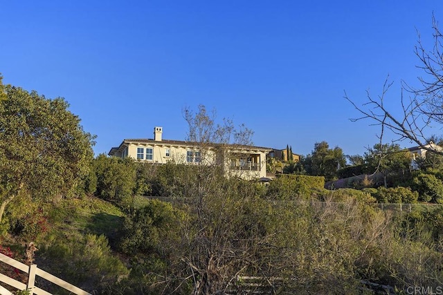 view of front of property featuring a chimney and fence