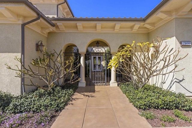 property entrance with stucco siding