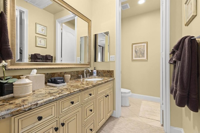 bathroom with vanity, tile patterned floors, toilet, and visible vents