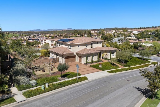 drone / aerial view featuring a residential view and a mountain view