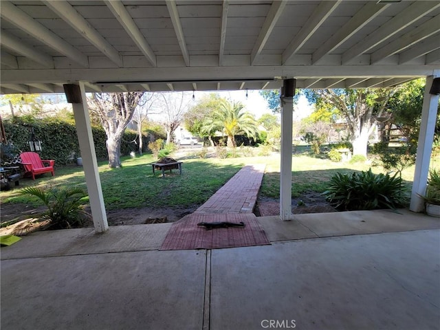 view of patio with a fire pit