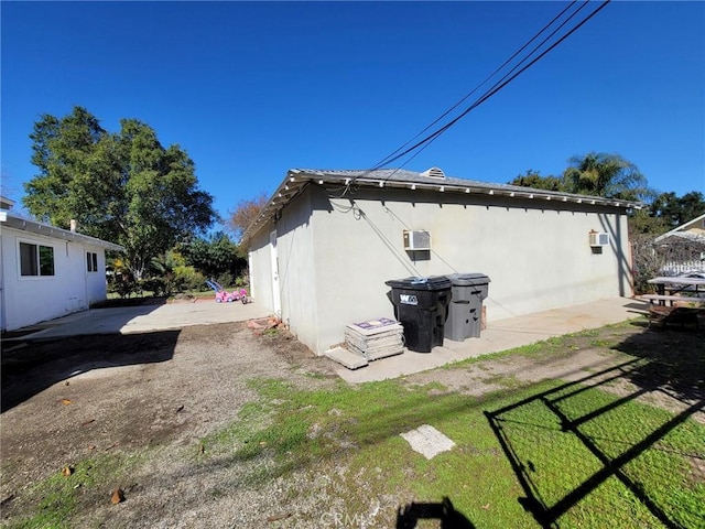 exterior space with a patio area and stucco siding