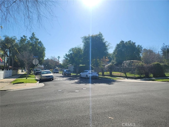 view of road with curbs, traffic signs, and sidewalks