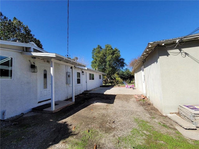 view of side of property with stucco siding