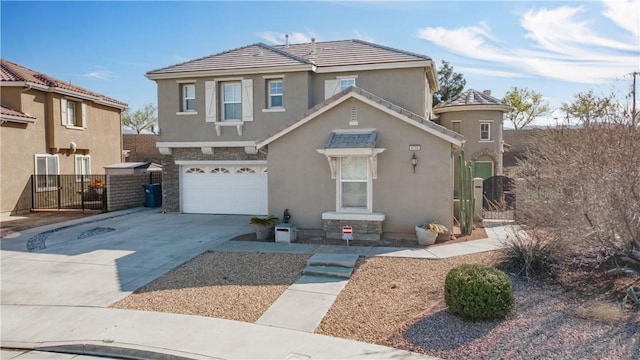 view of front of house featuring stucco siding, a gate, fence, concrete driveway, and a garage