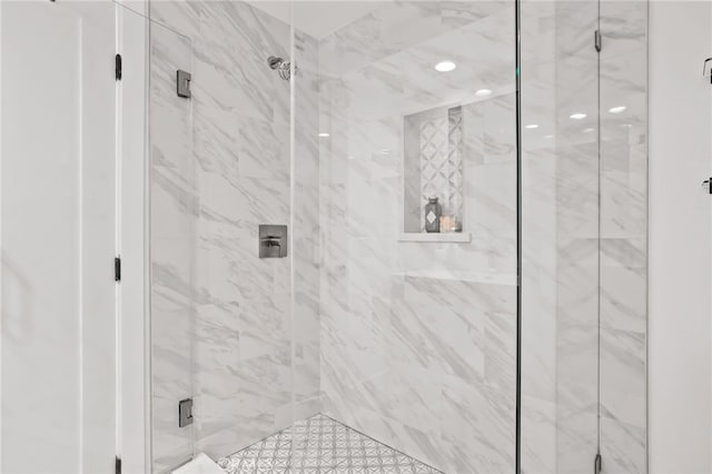 bathroom with a marble finish shower