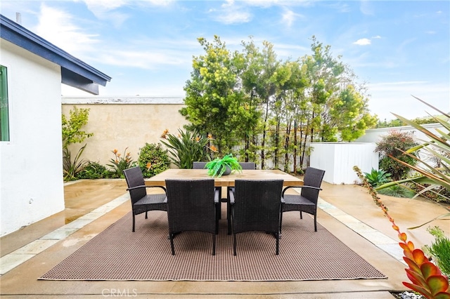 view of patio / terrace with outdoor dining area and fence