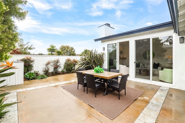 view of patio / terrace featuring outdoor dining area and fence