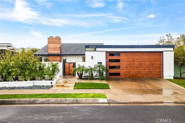 contemporary home featuring stucco siding and a chimney