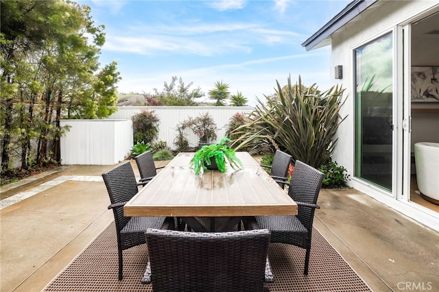 view of patio / terrace featuring outdoor dining area and fence