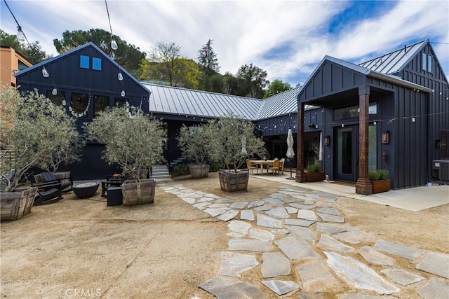 view of patio / terrace with central air condition unit and a fire pit