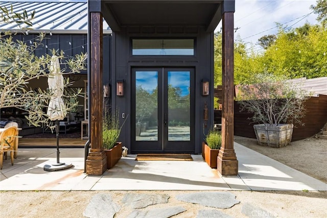 property entrance featuring french doors, a patio, and fence