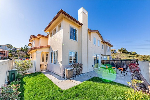 back of property featuring a patio area, central air condition unit, a fenced backyard, and stucco siding