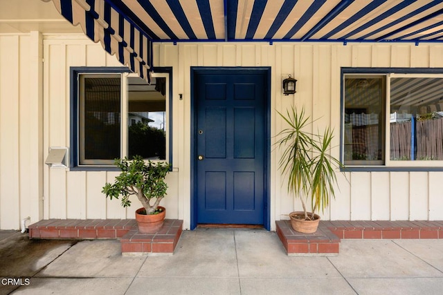 view of exterior entry featuring board and batten siding