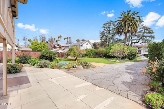 view of patio featuring fence and a residential view