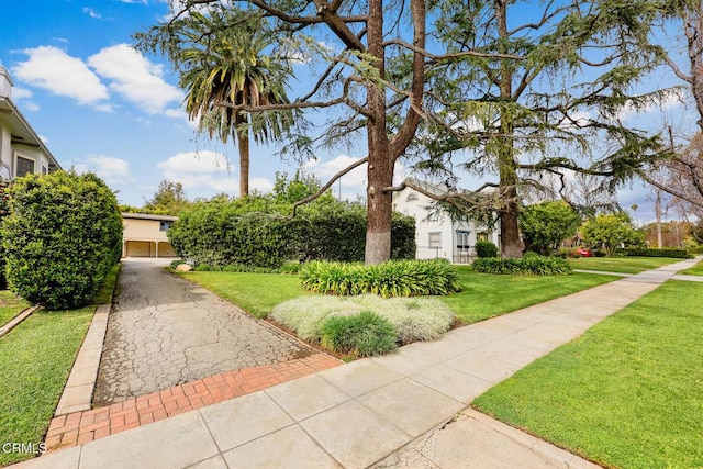 view of front of property with a front yard and a garage