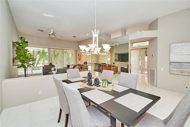 dining area with visible vents, ceiling fan with notable chandelier, and marble finish floor