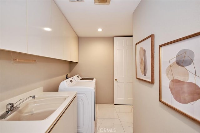 clothes washing area with recessed lighting, cabinet space, a sink, marble finish floor, and washer and clothes dryer