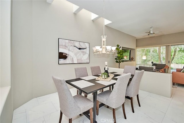 dining room with marble finish floor and ceiling fan with notable chandelier