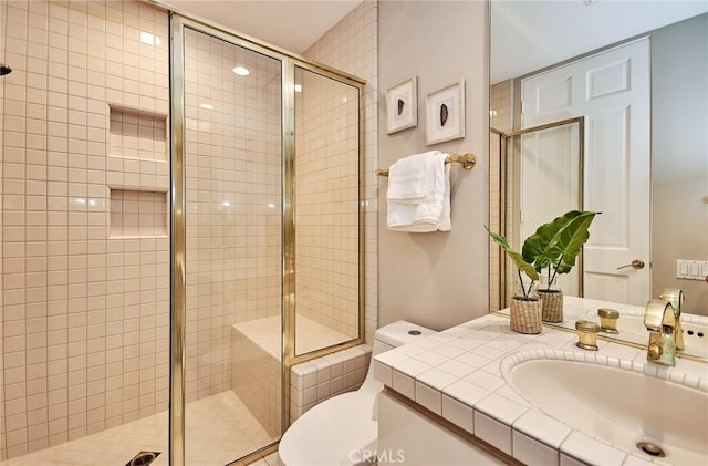 bathroom featuring toilet, a stall shower, and vanity