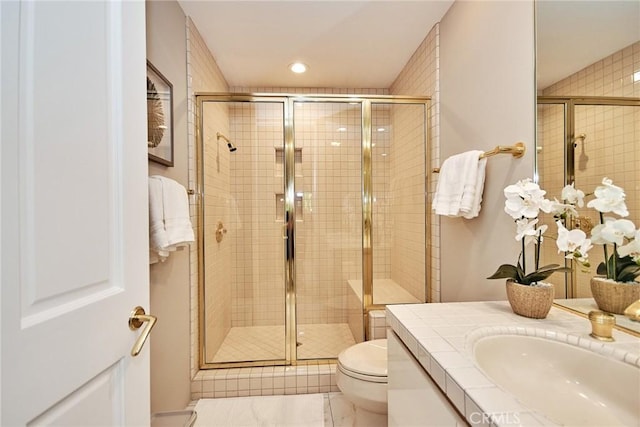 bathroom with vanity, a shower stall, toilet, and recessed lighting