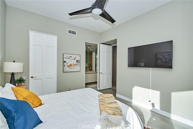 bedroom featuring visible vents, ceiling fan, ensuite bathroom, and baseboards