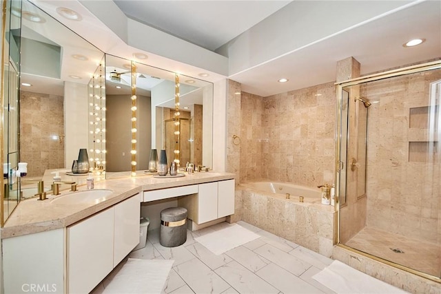 bathroom featuring vanity, recessed lighting, a stall shower, a garden tub, and marble finish floor