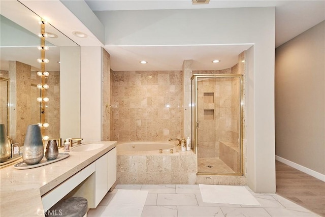 full bathroom with visible vents, baseboards, a garden tub, a stall shower, and vanity