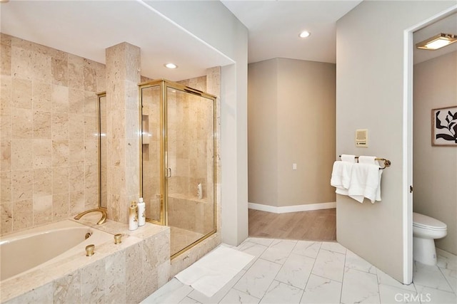 bathroom featuring a garden tub, marble finish floor, and a shower stall