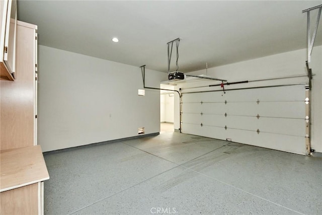 garage featuring recessed lighting and a garage door opener