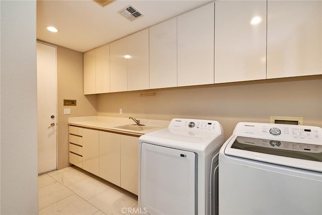 washroom featuring visible vents, recessed lighting, cabinet space, a sink, and washer and clothes dryer