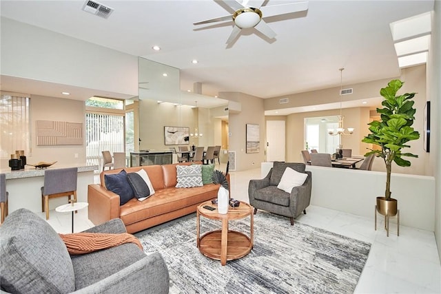 living room featuring recessed lighting, visible vents, marble finish floor, and ceiling fan with notable chandelier