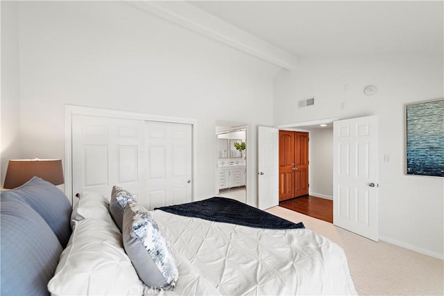 carpeted bedroom featuring baseboards, visible vents, high vaulted ceiling, beam ceiling, and a closet