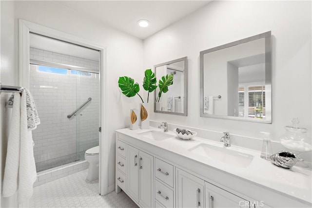 full bath with tile patterned flooring, a stall shower, toilet, and a sink