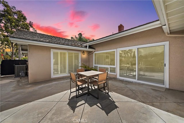 patio terrace at dusk with outdoor dining space