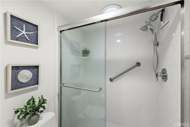 full bath featuring a shower stall and toilet