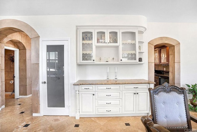 bar with arched walkways and dishwasher