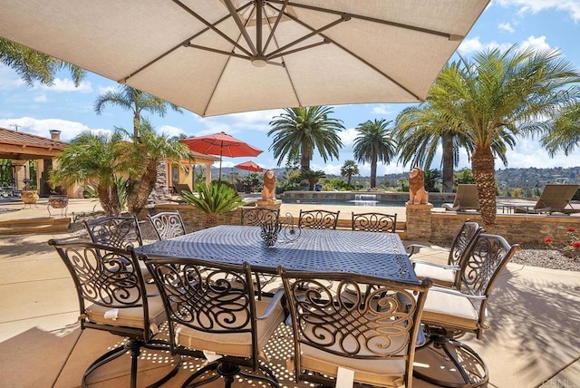 view of patio with outdoor dining area and a water view
