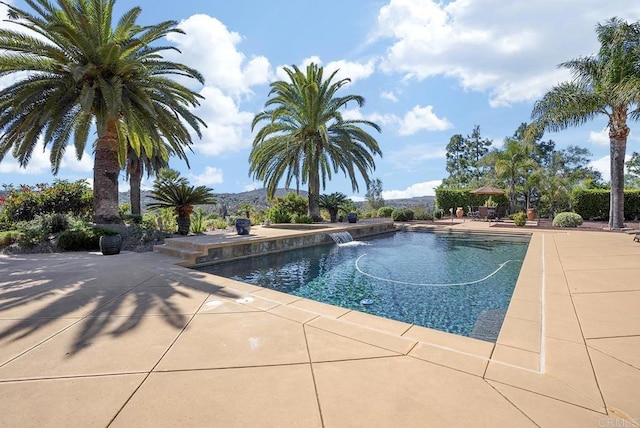 outdoor pool with a patio area