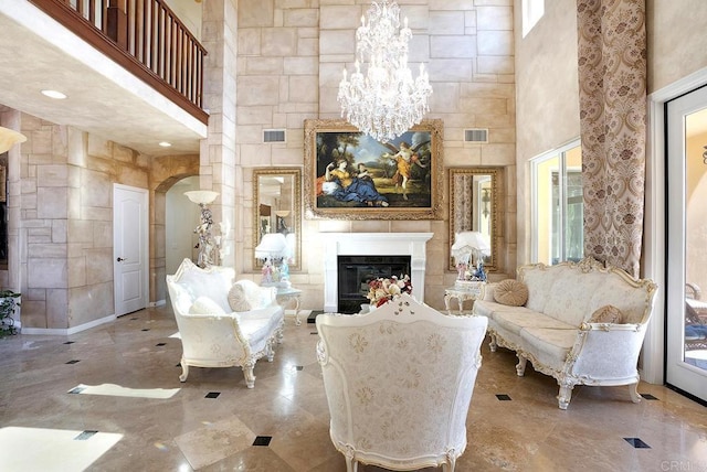 interior space with a fireplace, a high ceiling, and visible vents