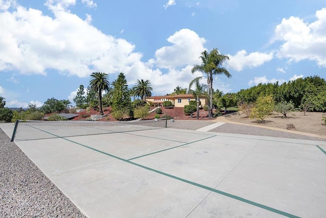 surrounding community with a tennis court