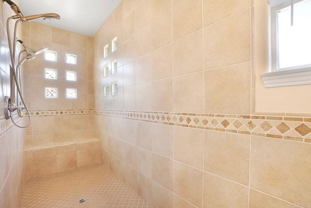 bathroom with a tile shower