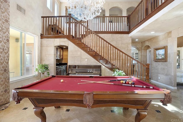 recreation room with visible vents, a high ceiling, a chandelier, and billiards