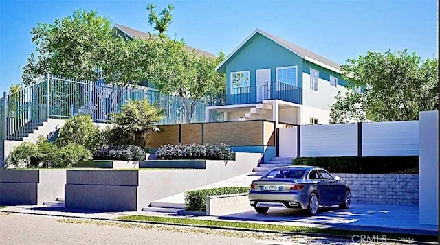 view of front facade featuring stairs and fence