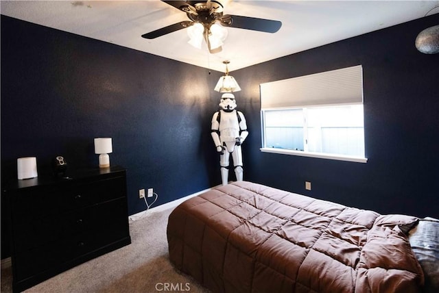 carpeted bedroom featuring a ceiling fan and baseboards