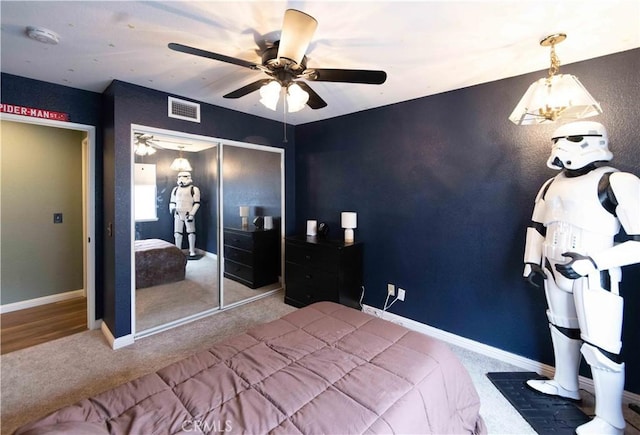 carpeted bedroom featuring a closet, visible vents, ceiling fan, and baseboards