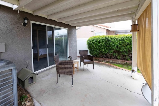 view of patio / terrace featuring central AC unit and fence